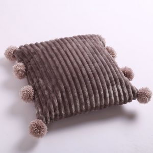 gray fluffy pom pom pillow