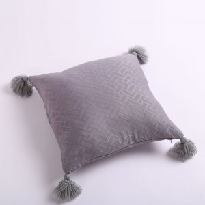 pillow with yarn tassels